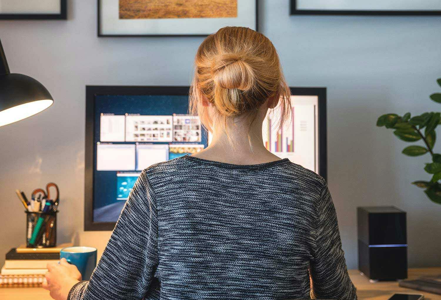 A woman sitting at her desk, working on a computer.