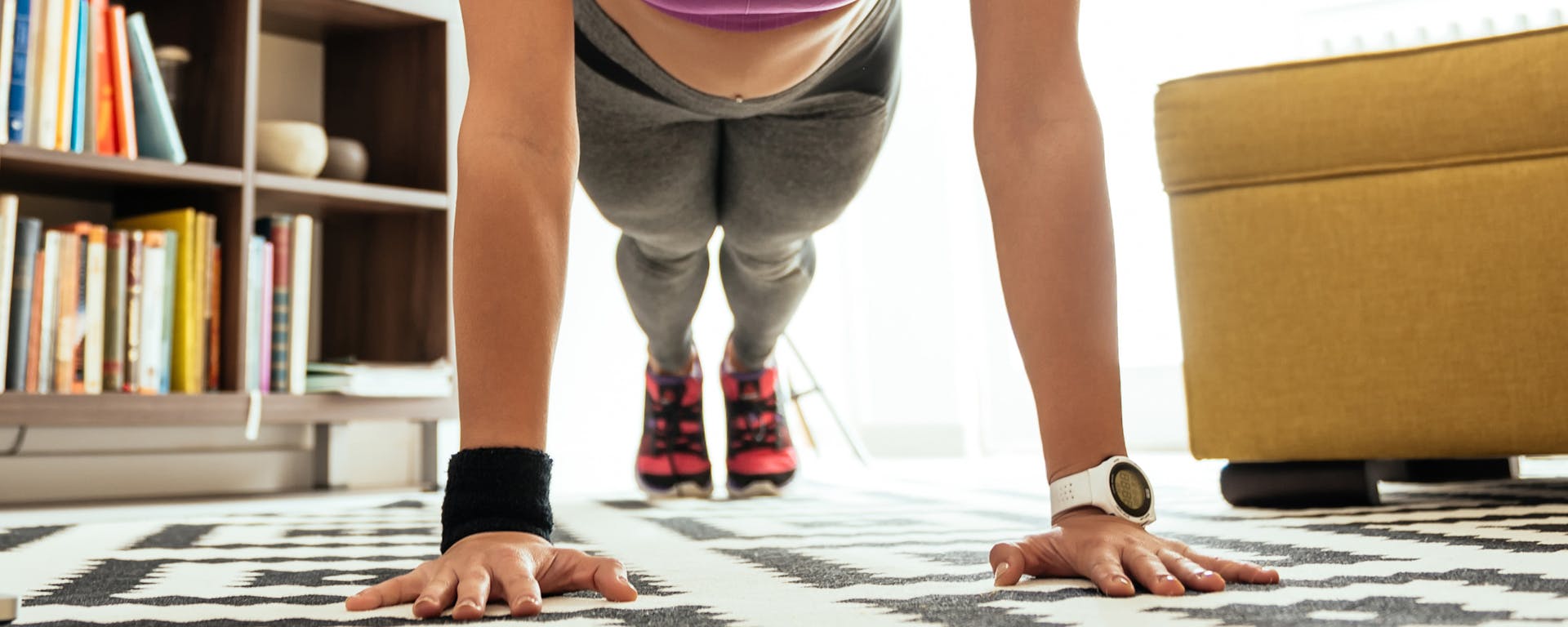 A person doing a pushup in their living room.