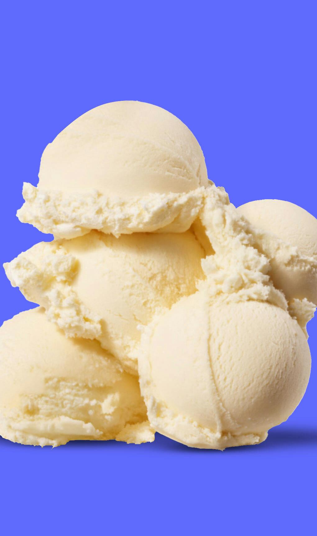 Scoops of vanilla ice cream against a blue background.