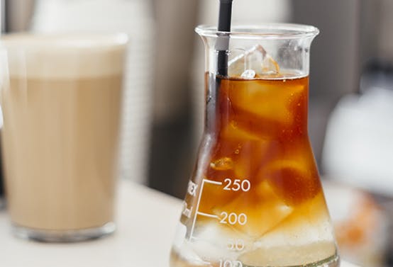 A photo of a protein shake being studied in a lab.